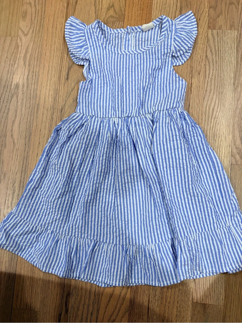 Toddler girl seersucker dress with buttons on the back and ruffle sleeves